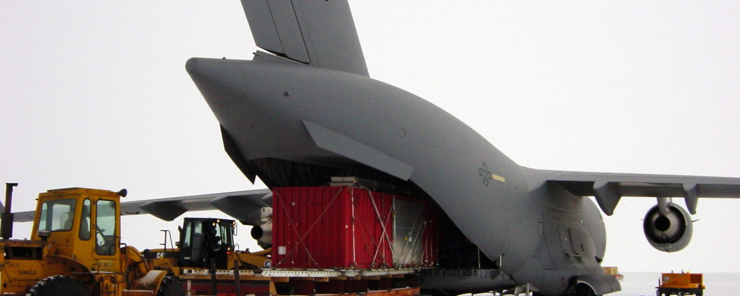 Loading shipping container into airplane